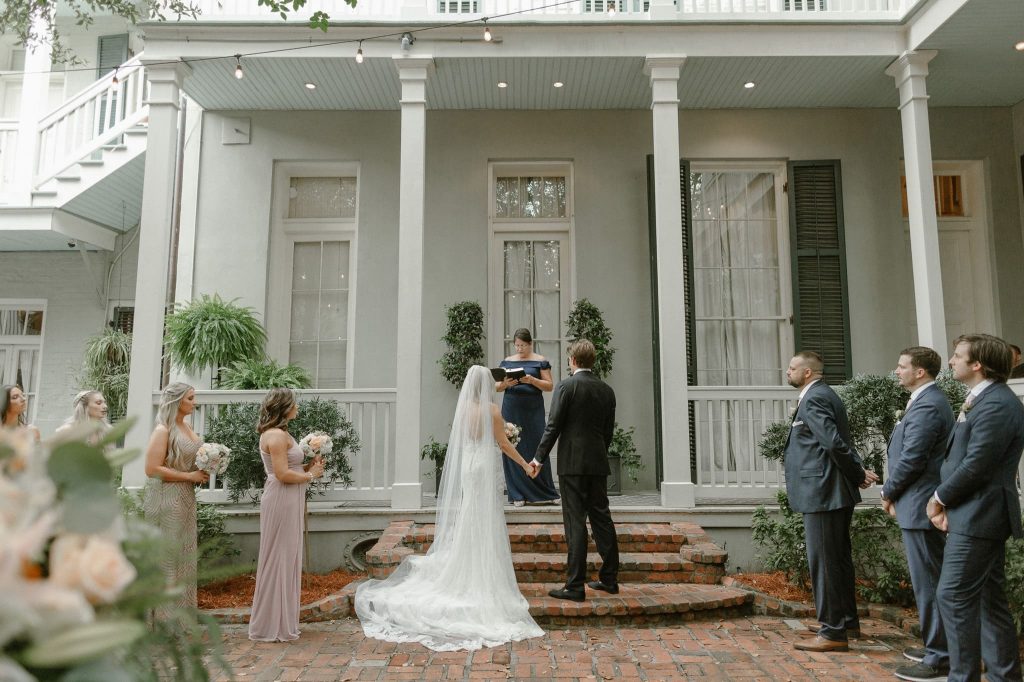 A wedding couple is getting married in front of the Terrell House in New Orleans.