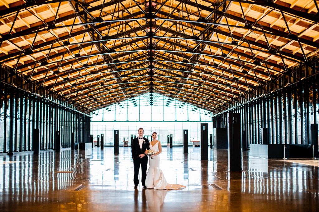 A wedding couple is standing at the Main Street Station, one of the wedding venues Richmond VA offers..