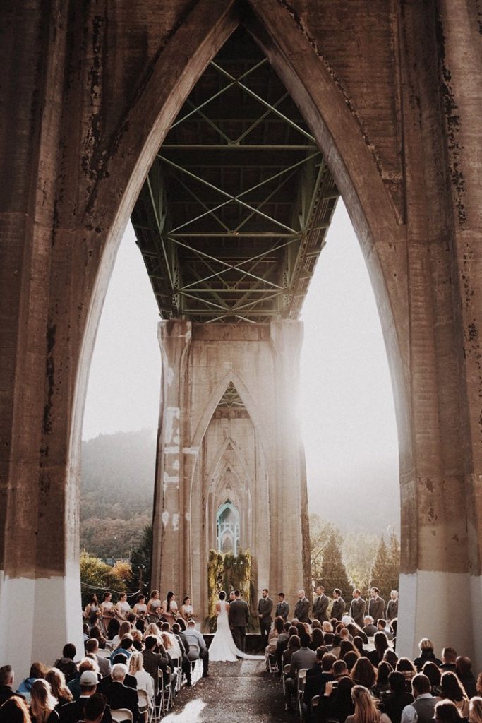 A wedding couple is getting married at the Cathedral Park, one of the Portland Wedding venues.