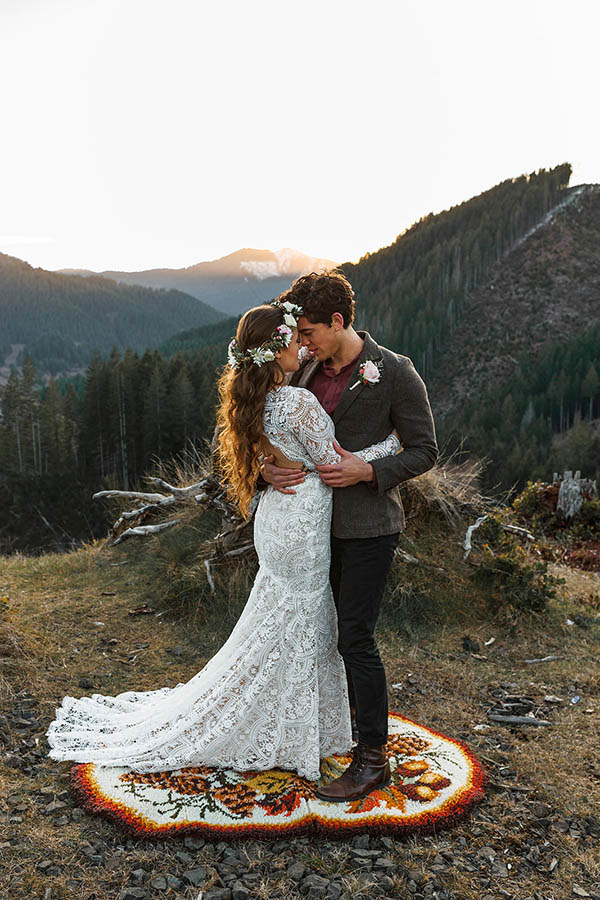 A wedding couple is holding each other and touching each others foreheads whilst standing in the Tillamook National Forest in Oregon.