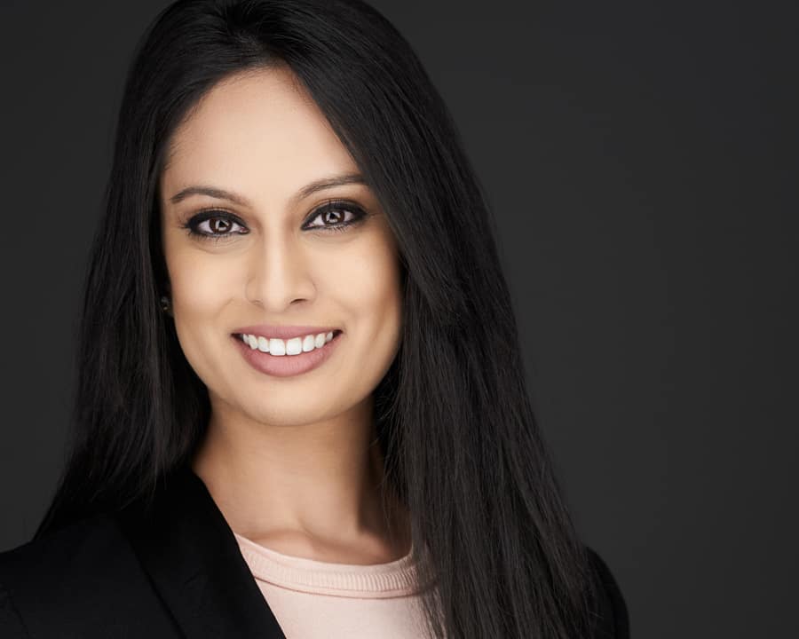 A woman looks straight into the camera while getting her Headshots Chicago done.
