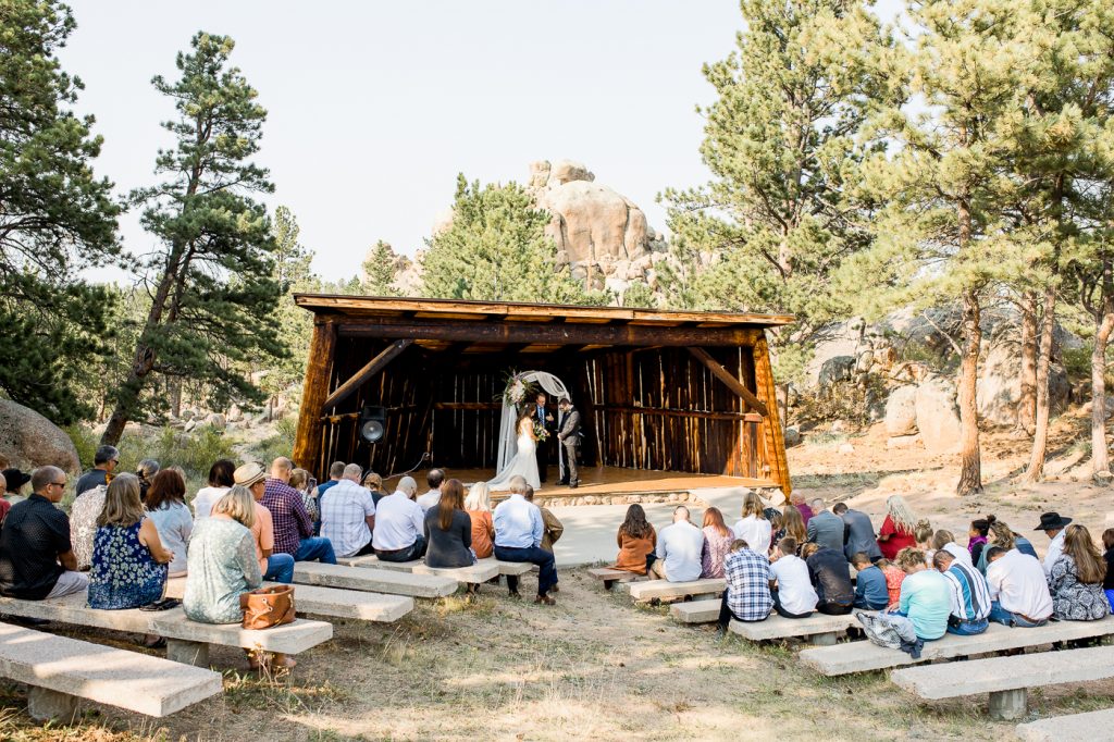 A wedding couple is getting married next to the Hynds Lodge at the Curt Gowdy State Park, one of the Wyoming wedding venues.