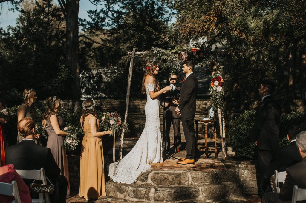 A wedding couple is standing at the HollyHedge estate, one of the Pennsylvania wedding venues.