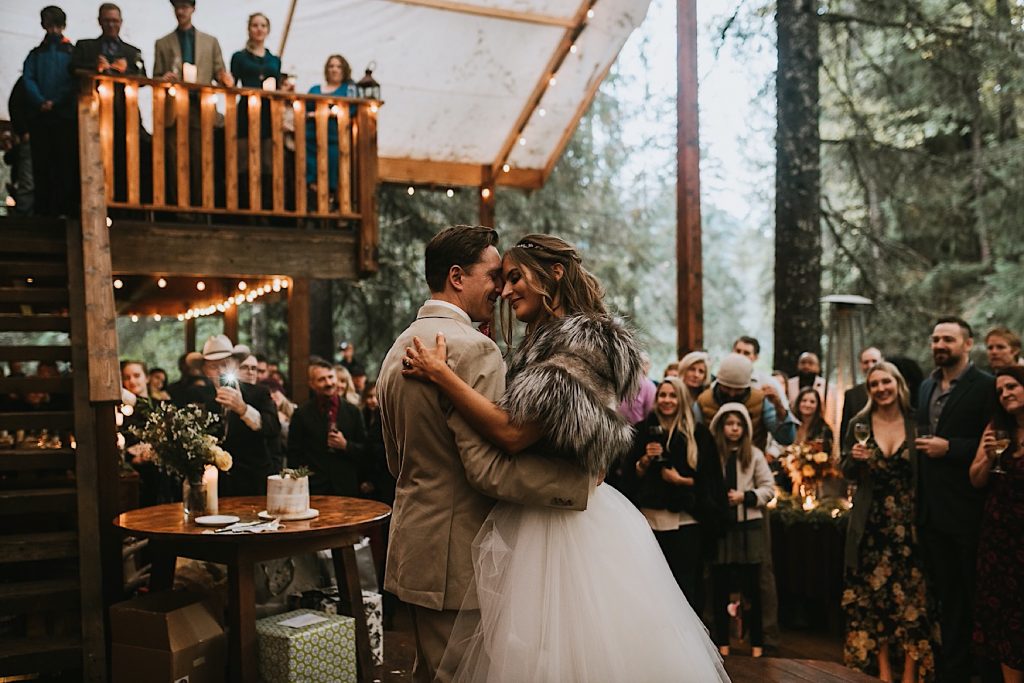 A wedding couple is dancing at the Raven Glacier Lodge , one of the Alaska wedding venues.