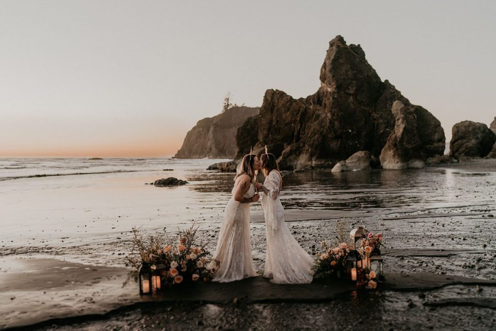 A wedding couple is kissing each other at Ruby Beach, one of the wedding venues Washington.