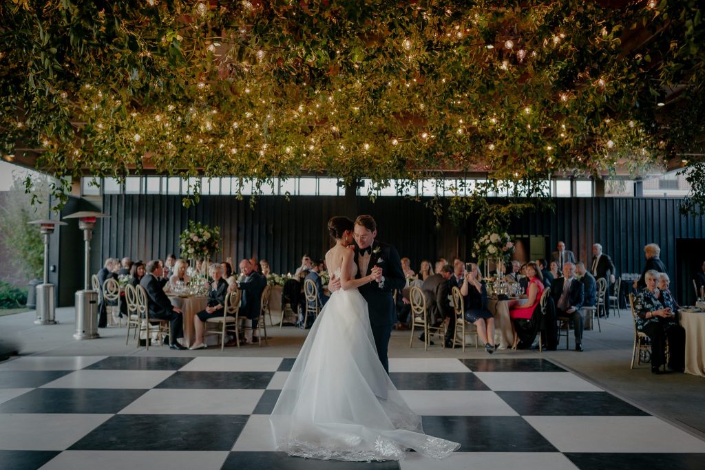 A wedding couple is having their first dance at the Shipe fo the Sea Maritime Museum, one of the Savannah wedding venues.
