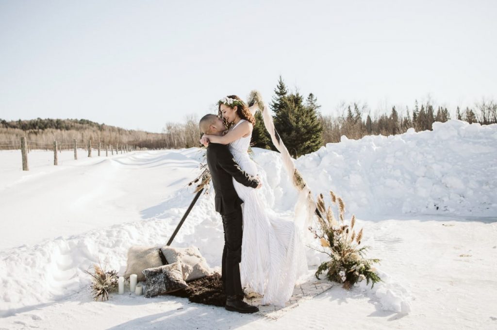 A wedding couple is holding each other outside at the Buffalo Farm, one of the wedding venues Ontario offers.