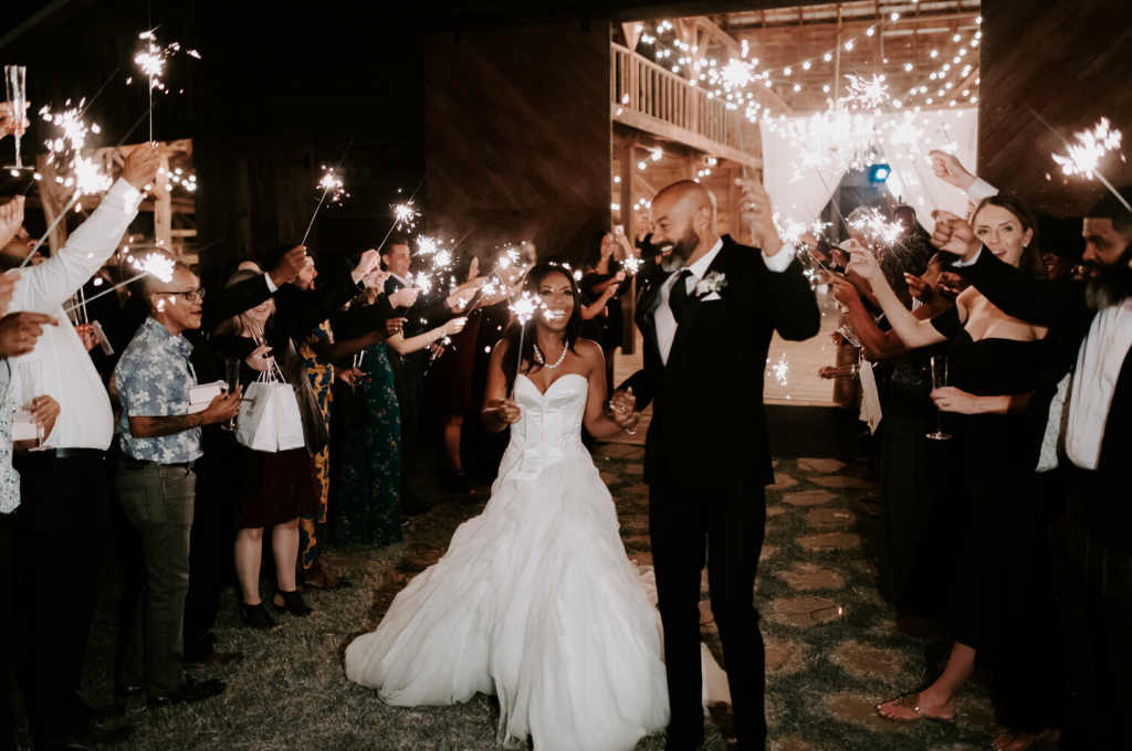 A wedding couple an their guests are celebration at the Barn at the Woodson of the wedding venues in Oklahoma.