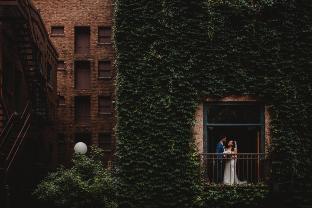 A wedding couple is standing at a balcony at the Ivy Room in Chicago, one of the wedding venues in Illinois.