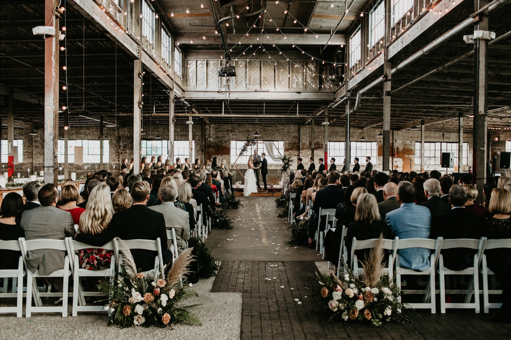 A wedding couple is getting married at the Glass Factory, one of the wedding venues Jacksonville FL offers.