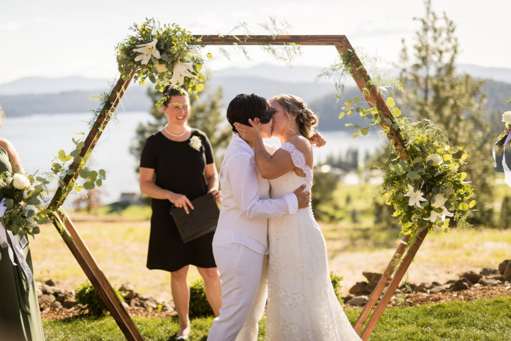 A wedding couple just got married and is kissing each other at Elk Point, one of the Idaho wedding venues.