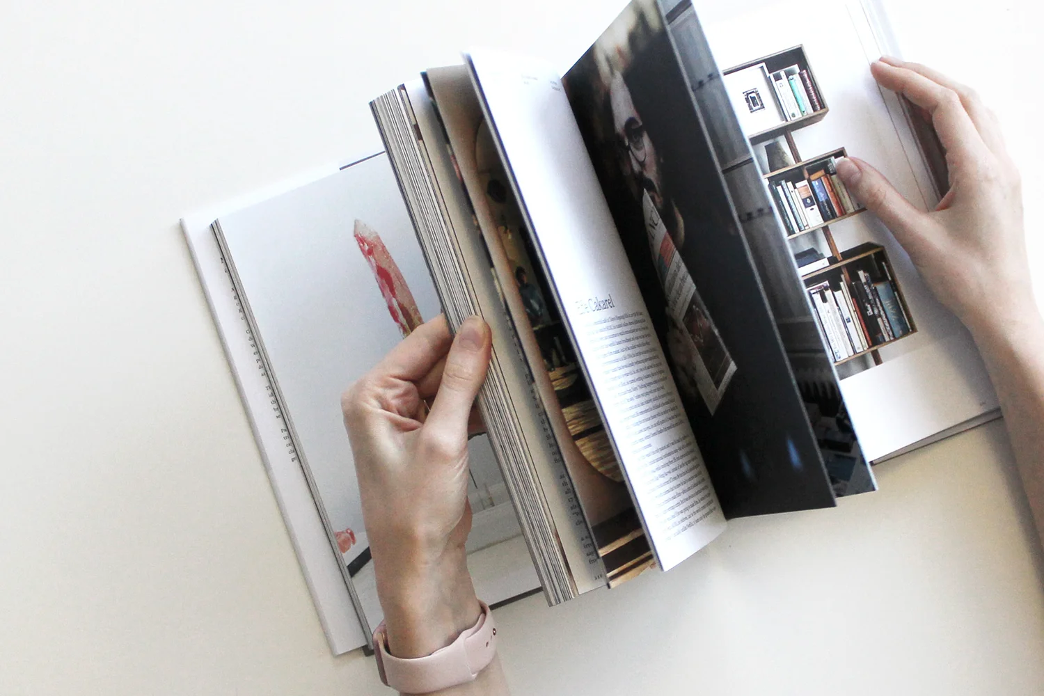 Hands gently flipping through the pages of a photo book, revealing a variety of captivating images that convey stories through visual art.